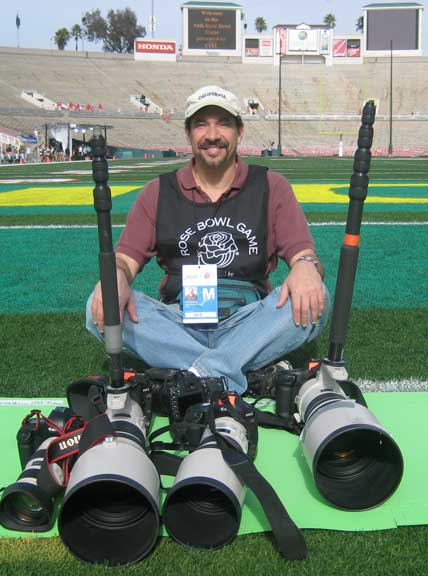 Dr. P sitting and smiling at the camera in the end zone with his camera equipment 4 hours before the Rose Bowl game