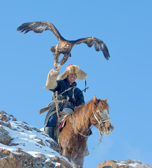 Kazakh nomad with his golden eagle hunting for fox
