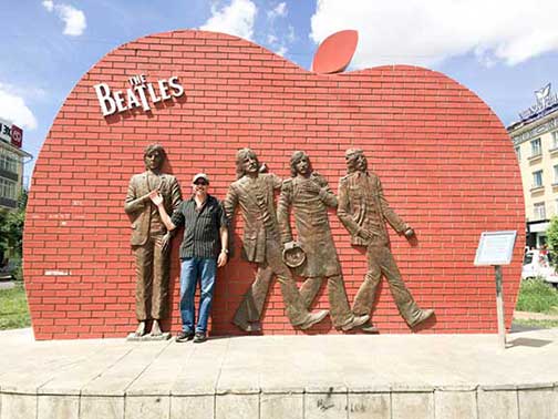 Dr. P in front of statues of the four Beatles in Ulan Bataar Mongolia