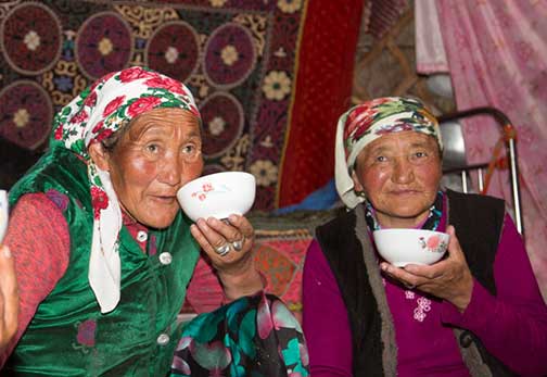 Nomad ladies drinking milk and tea prior to the mutton feast