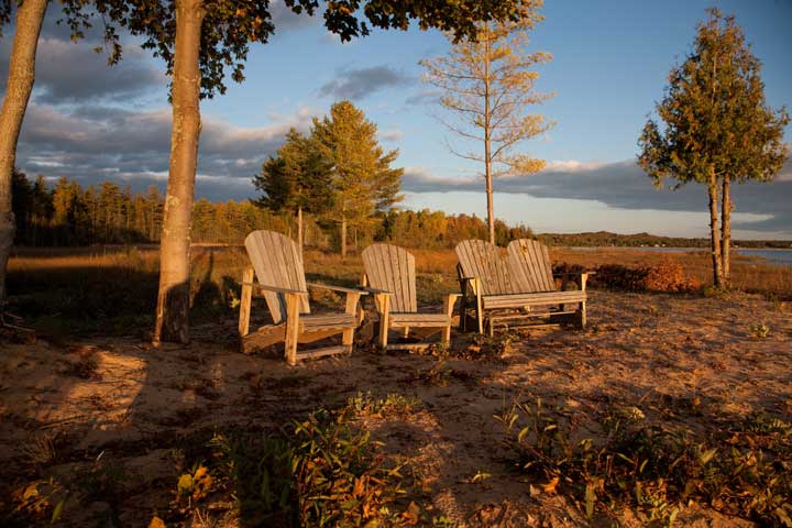 Adirondack wooden chairs at sunset in downtown Harbor Springs in northern Michigan