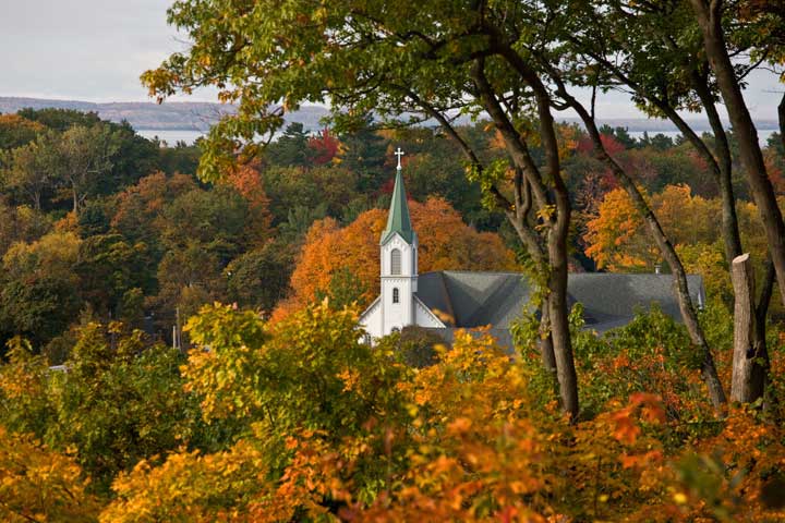 Autumn fall colors in downtown Harbor Springs church steeple northern Michigan