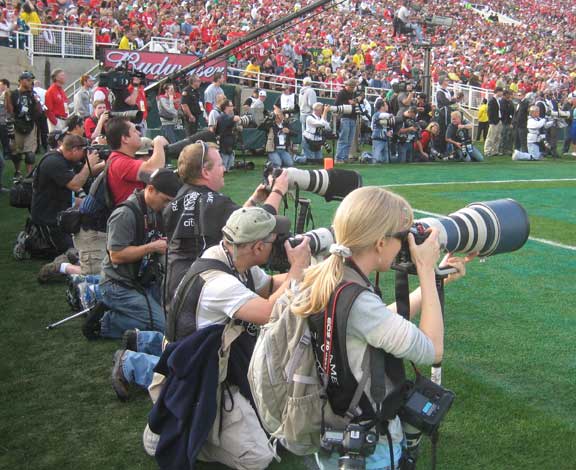 Professional photographers in the end zone shooting the Rose Bowl game