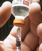 Removing the insulin from the bottle with the proper syringe
