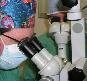 Dr. Jackson looking through the ophthalmic microscope