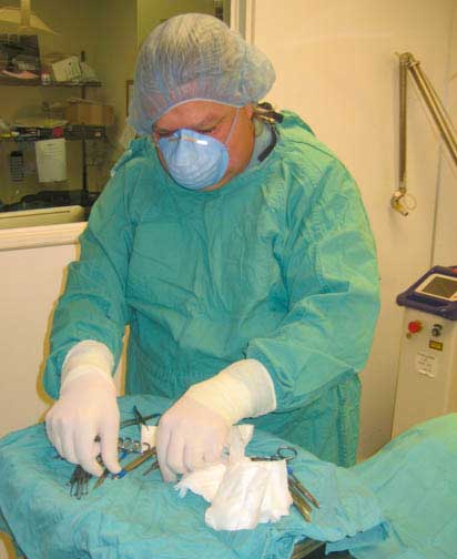 Dr. Ridgeway preparing sterile instruments prior to surgery